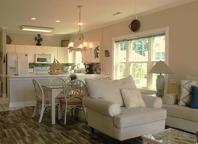 Living area with crown molding, a chandelier, light wood-type flooring, and recessed lighting