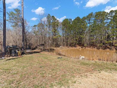 View of yard with a water view and a forest view