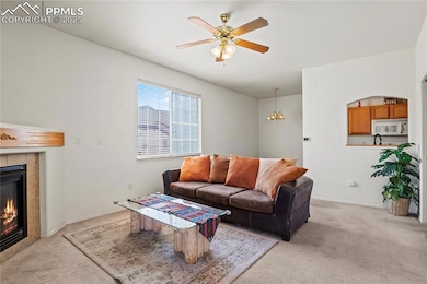Living room featuring a tile fireplace, light colo