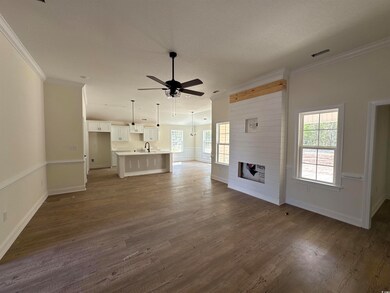 Unfurnished living room featuring crown molding, a