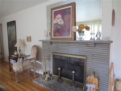 Living room features stone, log burning fireplace!
