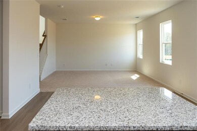 Empty room featuring stairs, dark wood-style floor