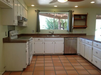 Large open kitchen has view of back yard