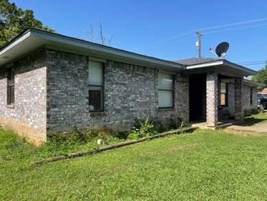 View of property exterior with a lawn