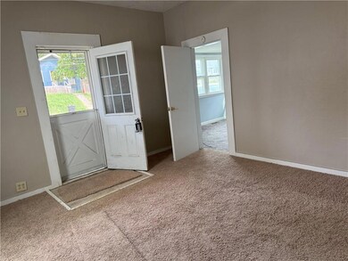 Doorway with carpet floors and a textured ceiling