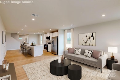 Expansive panoramic shot captures the effortless transition from the inviting great room to the heart of the home—the kitchen—highlighting open-concept living at its finest.
