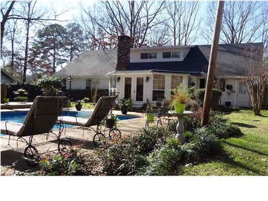 Rear view of sun room, pool and deck.