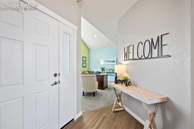 Foyer entrance with vaulted ceiling and hardwood /