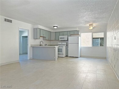 Kitchen featuring white appliances, a ceiling fan,