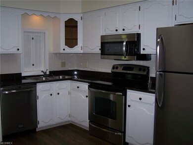The kitchen has granite counter tops and stainless
