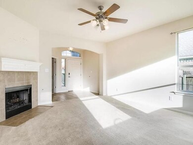 Unfurnished living room with carpet, a fireplace,