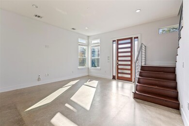 Entrance foyer with concrete flooring, stairs, and recessed lighting