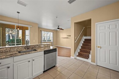 Kitchen featuring white cabinets, ceiling fan with