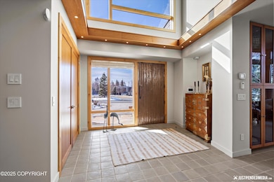 Sun-filled foyer w/bronze door