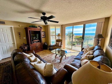 Tiled living room with a textured ceiling and ceil