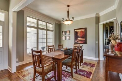 Large dining room w/ hardwood floors.
