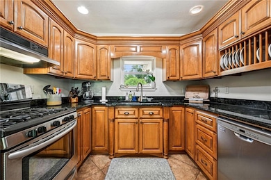 Beautifully updated kitchen with warm wood cabinet