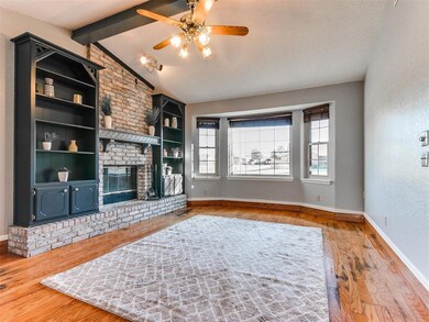 Living room with ceiling fan, lofted ceiling with 