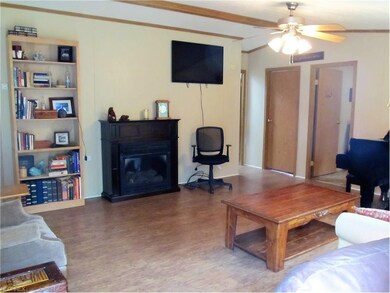 Another view of living room with fireplace and new