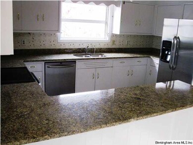 Open renovated kitchen with new tile, granite, and