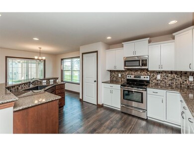 Kitchen view with raised breakfast bar.