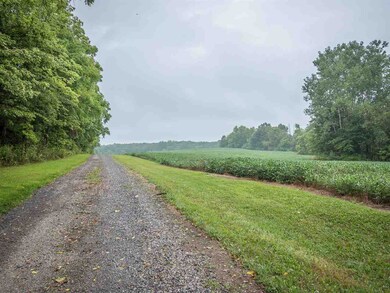 Stone drive leads up to home. Field to right is th