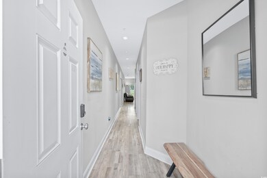 Hallway with light hardwood / wood-style flooring