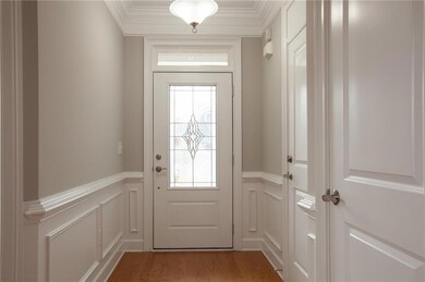 Beveled Glass Door to outside featuring a decorati