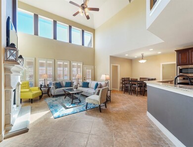 Family room with 18-ft ceiling, cast-stone fireplace and ceramic tile flooring!