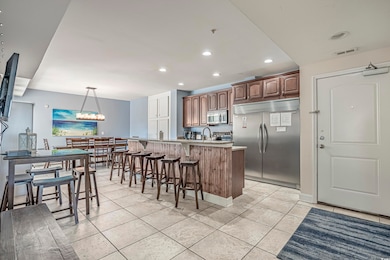 Kitchen with a breakfast bar, light tile patterned
