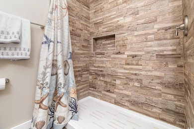 Bathroom featuring a tile shower