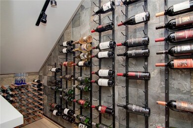 Custom wine cellar has plenty of room for any collection and the beautiful slate wall is a perfect display backdrop.
