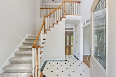 Entrance foyer with stairway, visible vents, crown