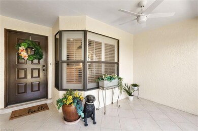Entrance to property featuring stucco siding, ceiling fan, and a sunroom