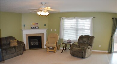 Bright and open family room with cozy gas fireplace flows seamlessly into the breakfast room and kitchen.