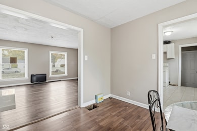 unfurnished dining area featuring dark wood-type flooring and a textured ceiling