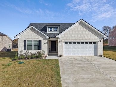 Front of home with spacious driveway.