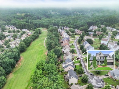 Aerial view of residential area with a heavily wooded area and a golf club