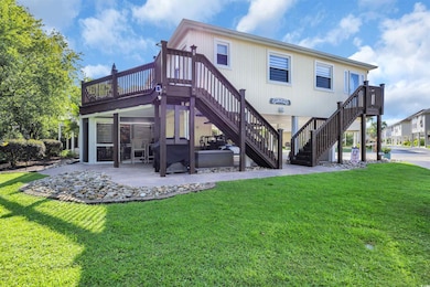 Back of property with stairs, a lawn, and a patio