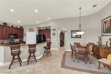 Dining room with lofted ceiling, recessed lighting