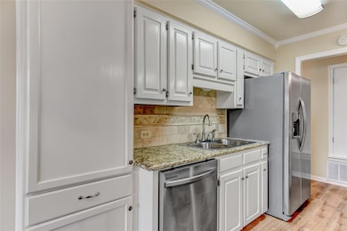 Kitchen with crown molding, visible vents, white c