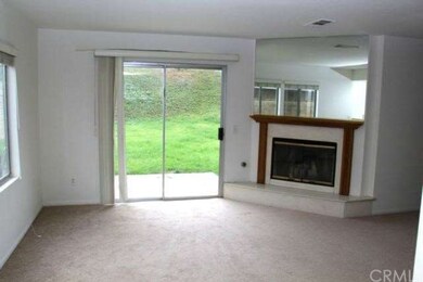 Family room with fireplace overlooking backyard