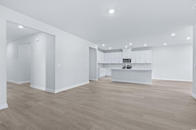 Unfurnished living room featuring light hardwood /
