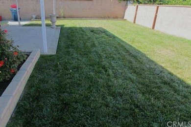 Flower Beds, Green Grass and Sprinklers