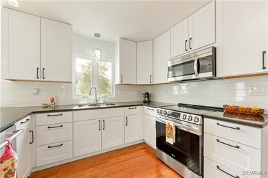 Renovated hardwood style floors, sink, and white c