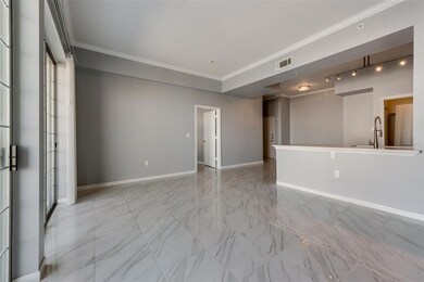 Living room with view of kitchen, bedroom door and
