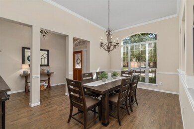 Large dining room complete with tall ceilings, crown molding and beautiful windows that allow lots of natural light in.