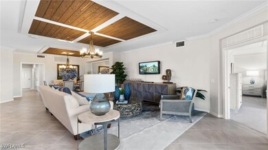 Tiled living room featuring a chandelier, wood cei