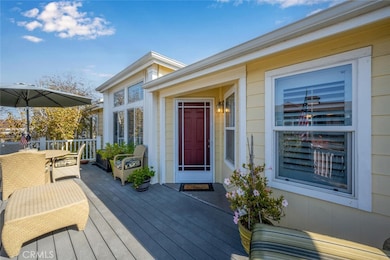 Patio decking constructed of long lasting synthetic simulated wood planks.