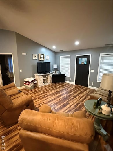 Living area with recessed lighting and wood finished floors